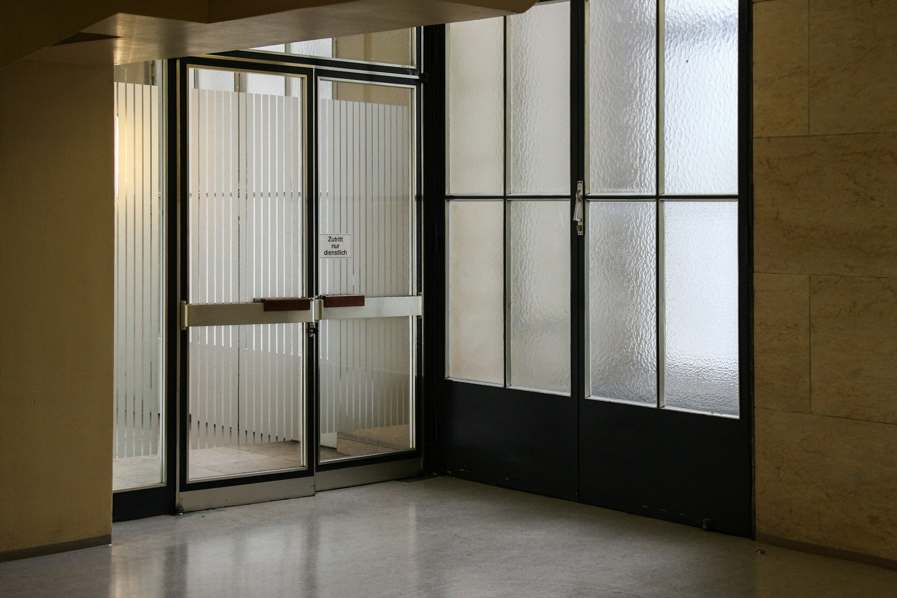 A closed steel-framed glass door at a business entrance