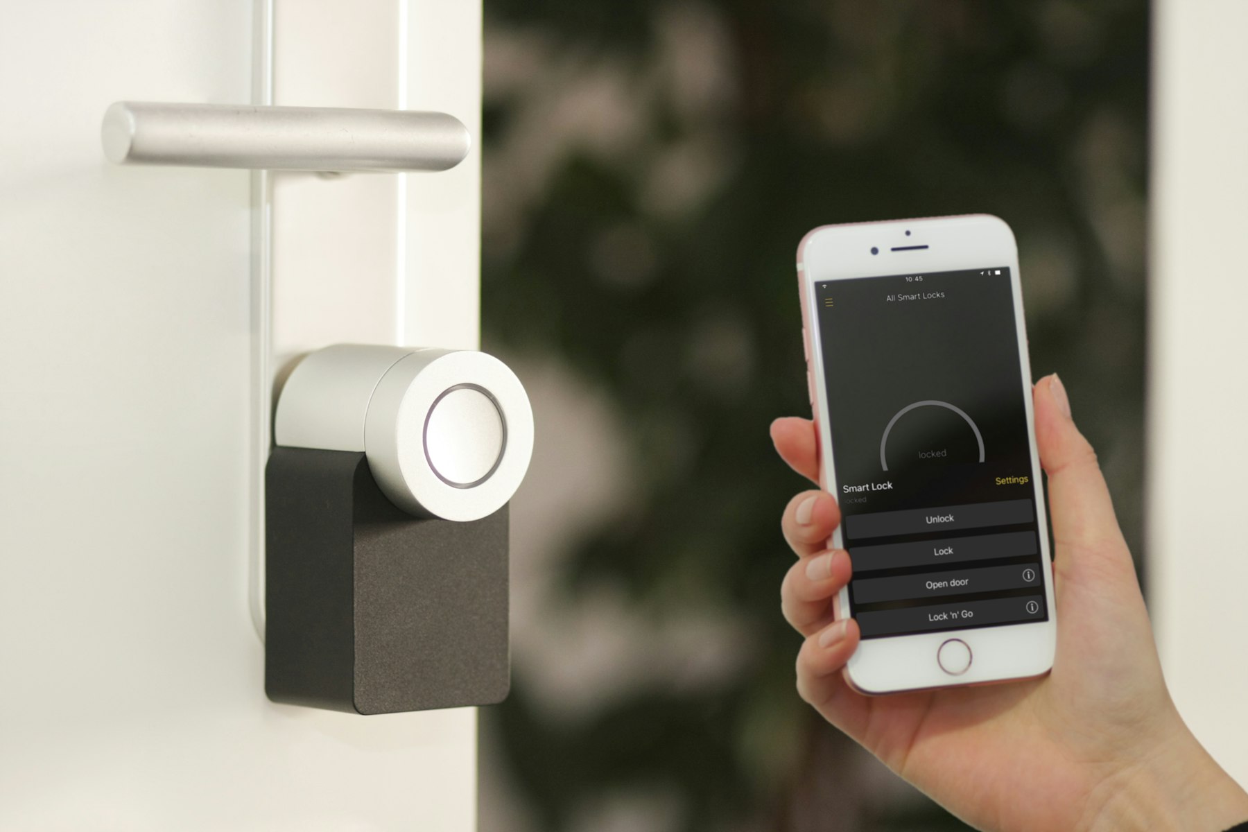 A phone held up to a smart lock on a front door