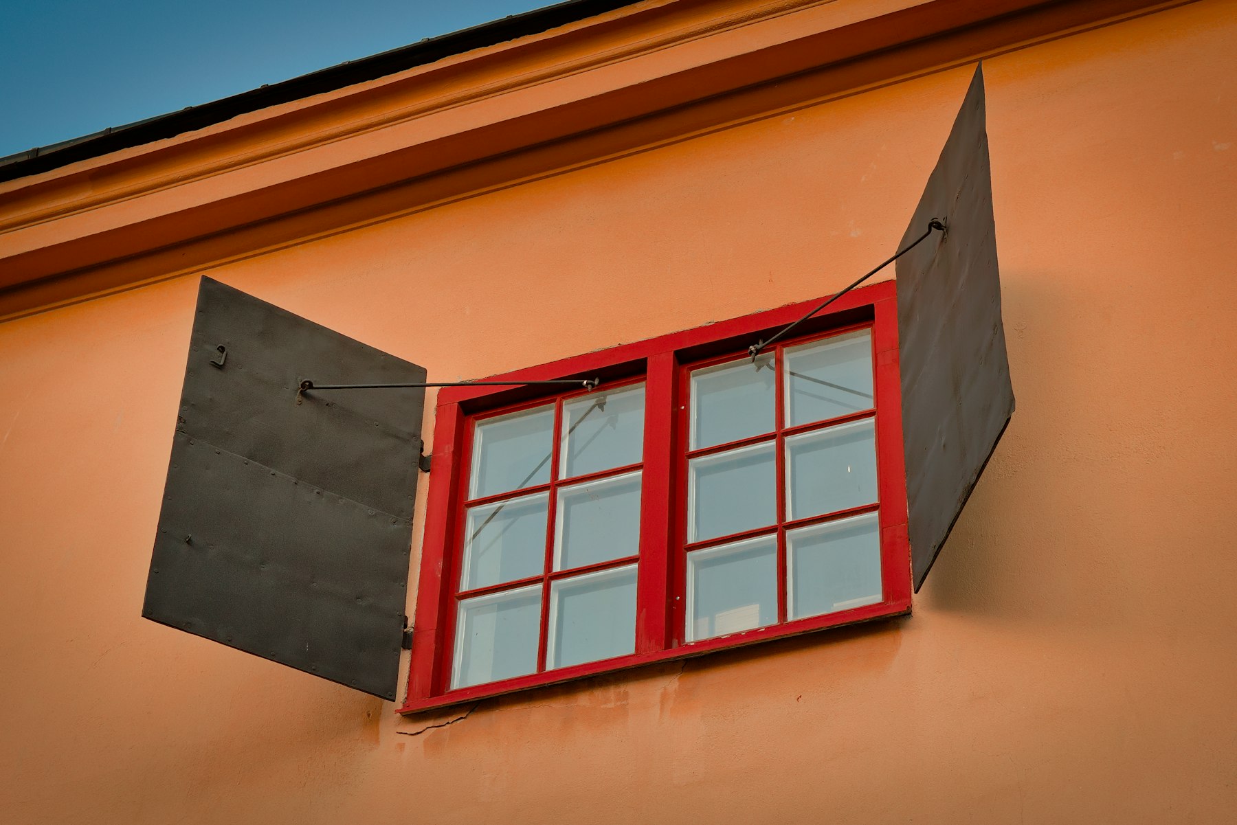 An opened white wooden-framed window